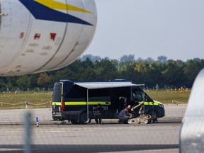 Police investigators work on the tarmac with a robot capable of defusing explosives near a Ukrainian Antonov cargo plane at Leipzig/Halle Airport on August 5, near Leipzig, Germany. Airport workers reportedly discovered a drone yesterday on the tarmac near an Antonov at the airport that was equipped with an explosives detonator and an unidentified substance. Additionally, a DHL cargo plane that took off from the airport late last night collided with a small object, causing minor damage.