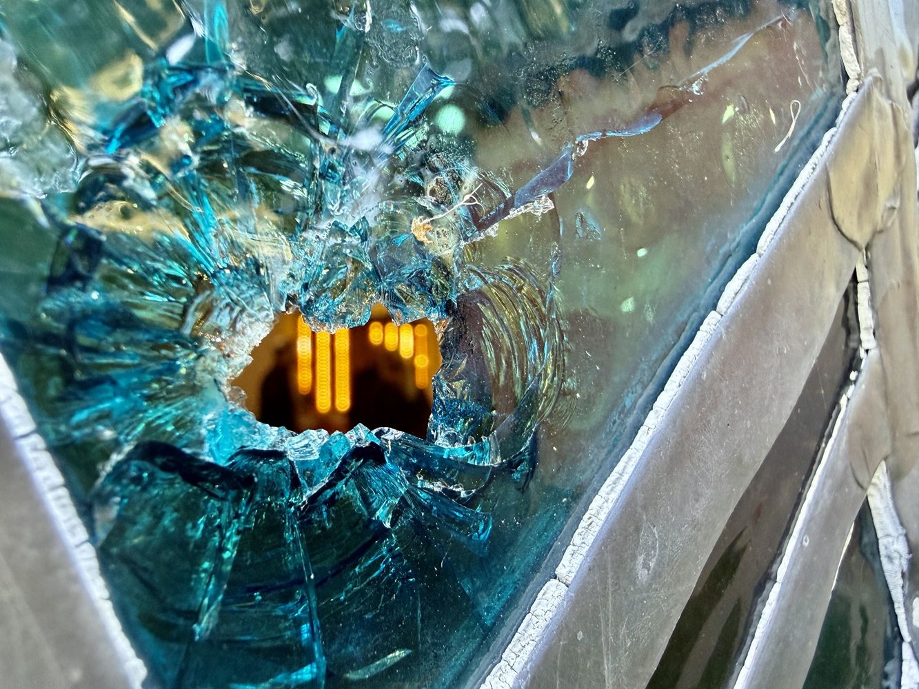 Bullet holes in the stained glass windows at the Sons of Jacob Synagogue in Belleville, Ont.