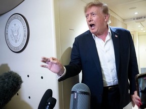 US President Donald Trump speaks to the press aboard Air Force One while flying to Joint Base Andrews, Maryland from Ireland on Sunday.