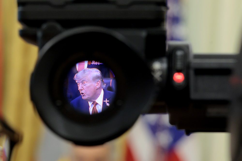 U.S. President Donald Trump is seen in the electronic viewfinder of a television camera as he speaks to reporters.