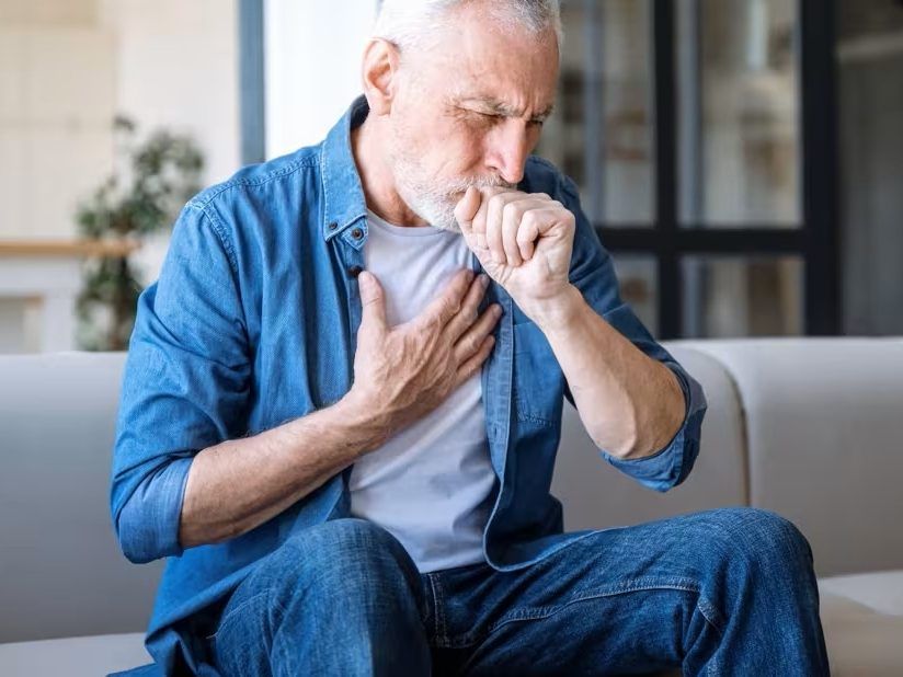 Man having asthma attack, difficulties breathing, feeling chest pain.