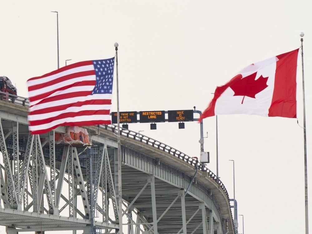 The US and Canadian flags fly