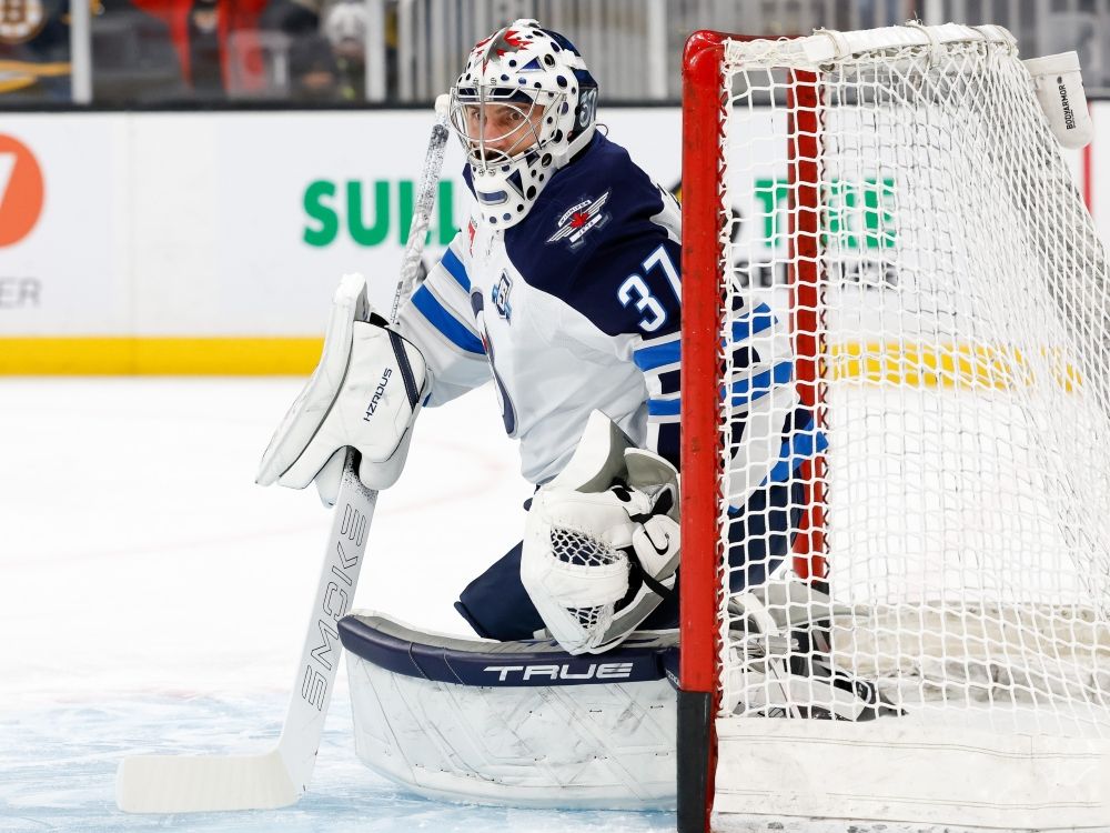 Connor Hellebuyck of the Winnipeg Jets warms up prior to a game against the Boston Bruins last season.