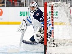 Connor Hellebuyck of the Winnipeg Jets warms up prior to a game against the Boston Bruins last season.