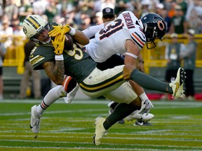 Christian Watson of the Green Bay Packers catches a touchdown pass against Dillon Thieneman of the Chicago Bears.