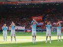 Rayan Cherki, Erling Haaland, Elliot Anderson, Ruben Dias and Enzo Fernandez of Manchester City applaud the fans before a Premier League against Liverpool FC.