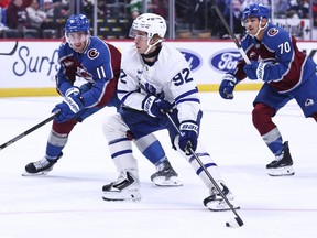 Brock Nelson of the Colorado Avalanche defends against Gavin McKenna of the Toronto Maple Leafs.