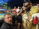 WWE superstar Montez Ford dances in front of a security guard.