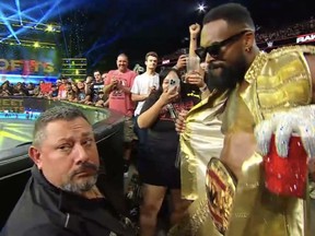 WWE superstar Montez Ford dances in front of a security guard.