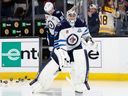 Connor Hellebuyck of the Winnipeg Jets warms up prior to a game against the Boston Bruins earlier this year.