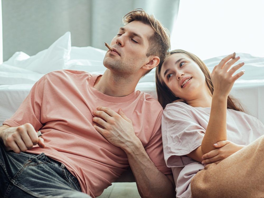 A young couple enjoy smoking cannabis marijuana