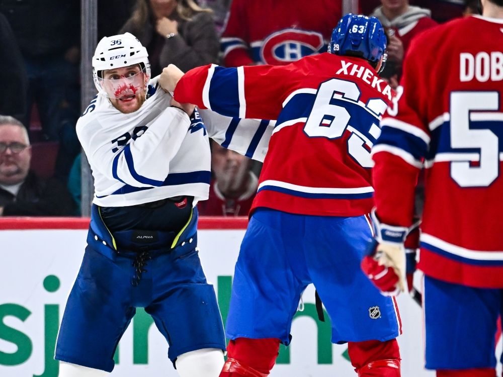 Florian Xhekaj of the Montréal Canadiens opens up Dakota Mermis of the Toronto Maple Leafs in a fight during a game last year.