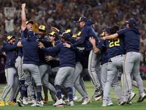 The Milwaukee Brewers celebrate on the field