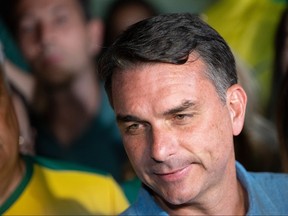 Flavio Bolsonaro speaks to the press.
