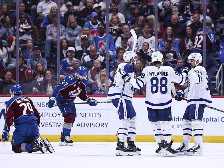 Maple Leafs (from left) Nick Paul, William Nylander and Auston Matthews celebrate a goal against the Colorado Avalanche in the second period at Ball Arena in Denver last night. The three Leafs combined for 11 points in a 6-3 win. 
