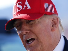 U.S. President Donald Trump speaks to members of the media before boarding Air Force One as he departs Laughlin/Bullhead International Airport following a rally on Wednesday, Oct. 14, 2026, in Bullhead City, Ariz. Trump is traveling to Arizona and Montana to campaign for Republican candidates ahead of the midterm elections.