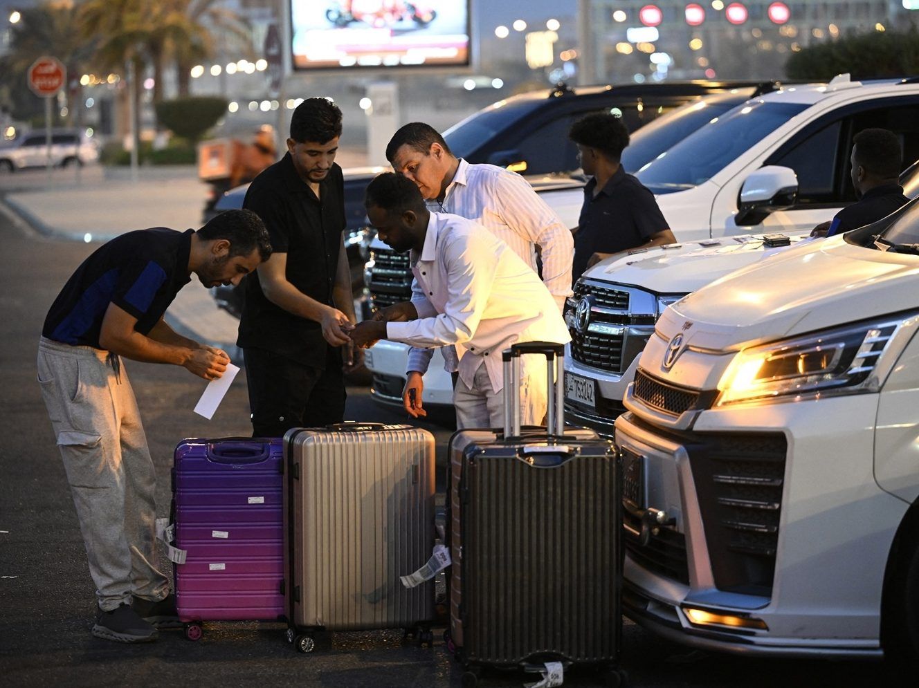 Travellers prepare to depart by road for Saudi Arabia.