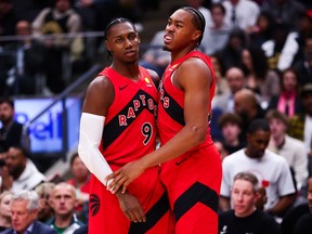 Scottie Barnes of the Toronto Raptors reacts alongside teammate RJ Barrett.