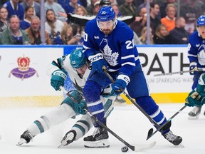 Zack Ostapchuk of the San Jose Sharks battles for the puck with Nick Paul of the Toronto Maple Leafs in the second period at Scotiabank Arena on Monday, Oct. 19, 2026, in Toronto.