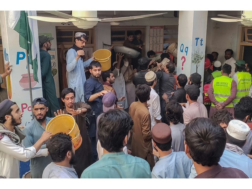 Rescuers and residents gathered at the school to conduct a search operation at a school after a deadly roof collapse. (Abdul MAJEED/AFP)