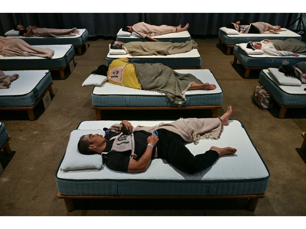 The Tokyo competition, dubbed “Matt Race”, saw dozens of participants fitted with sleep tracking devices sprawl on comfy mattresses to slumber for up to 90 minutes. (Selim CHTAYTI/AFP)