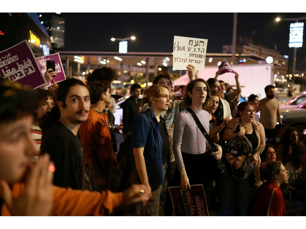 Israeli left-wing activists in Tel Aviv hold placards during a protest calling for a formation of a government together with Arab parties. (Ilia YEFIMOVICH/AFP)