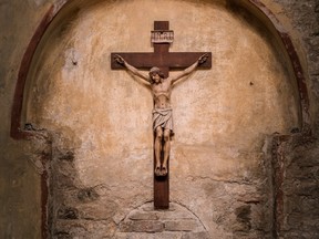 Wooden crucifix on aged church wall