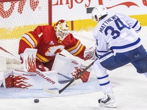Flames goaltender Devin Cooley blocks a shot by Maple Leafs centre Austin Matthews during second period NHL action at the Scotiabank Saddledome in Calgary, Monday, Oct. 26, 2026.