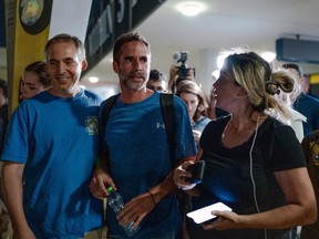 Assaf Regavim (centre), who helped subdue the pilot during a Flydubai flight, smiles as he talks with friends and relatives amidst waiting crowds at Ben Gurion Airport in Tzafria, Israel, Wednesday, Sept. 30, 2026.