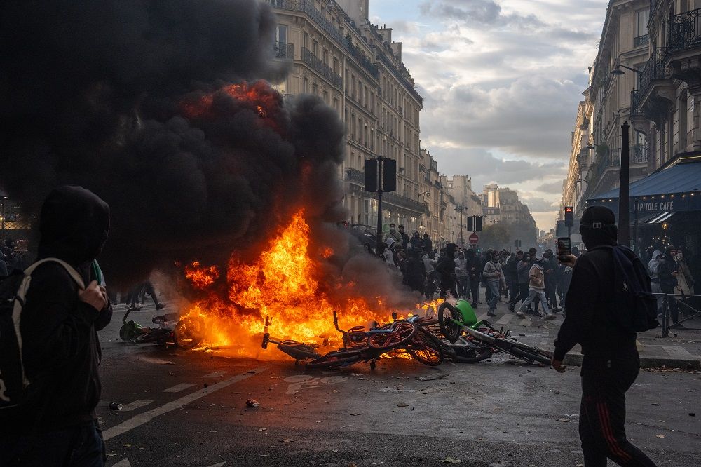 A fire burns in a street during demonstrations on October 17, 2026 in Paris, France.