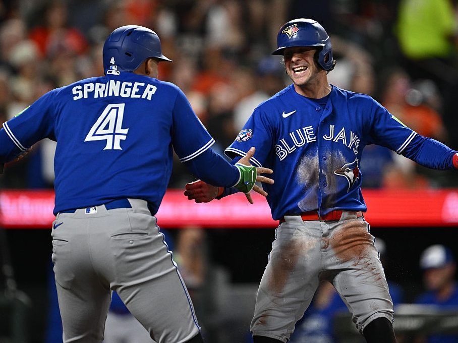 Ernie Clement #22 of the Toronto Blue Jays, right, celebrates with George Springer #4 after scoring the go-ahead run in the eighth inning against the Baltimore Orioles at Oriole Park at Camden Yards on May 29, 2026 in Baltimore, Maryland.