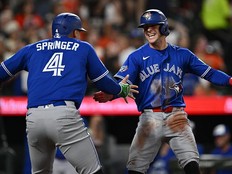 Ernie Clement #22 of the Toronto Blue Jays, right, celebrates with George Springer #4 after scoring the go-ahead run in the eighth inning against the Baltimore Orioles at Oriole Park at Camden Yards on May 29, 2026 in Baltimore, Maryland.