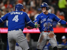 Ernie Clement #22 of the Toronto Blue Jays, right, celebrates with George Springer #4 after scoring the go-ahead run in the eighth inning against the Baltimore Orioles at Oriole Park at Camden Yards on May 29, 2026 in Baltimore, Maryland.