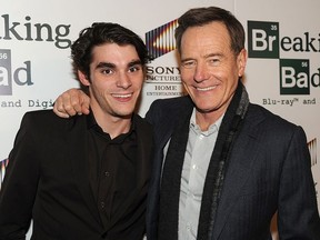 Actors RJ Mitte (L) and Bryan Cranston arrive at the screening of "No Half Measures: Creating The Final Season Of Breaking Bad" DVD Launch at Pacific Theatres at the Grove on November 25, 2013 in Los Angeles, California.