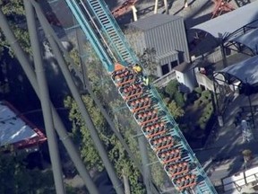 In this screengrab from WXIA, TV in Atlanta, workers try to get riders off the Goliath roller coaster at Six Flags Over Georgia.