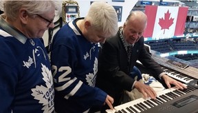 Canadian actors Dave Foley, left, and Mike Myers get an up-close look at Maple Leafs organist’s Jimmy Holmstrom’s setup. SUPPLIED PHOTO