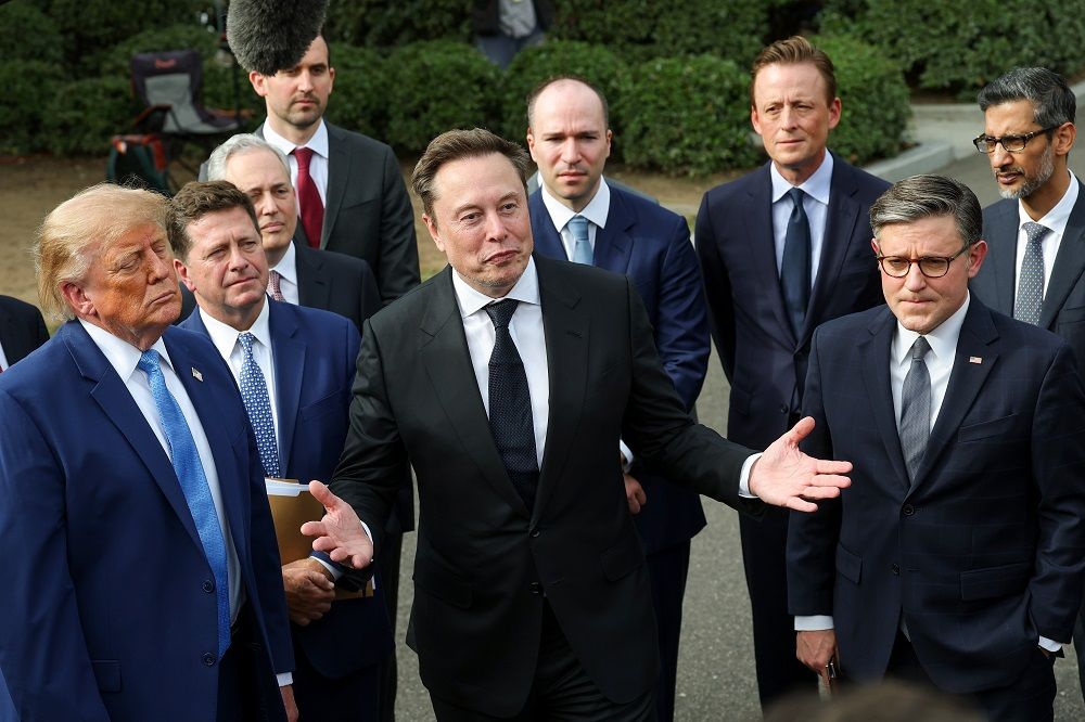 Tesla, SpaceX and X CEO Elon Musk (C) speaks as U.S. President Donald Trump (L) holds a press briefing with AI executives following a meeting on artificial intelligence outside the West Wing of the White House in September.