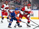 Oilers captain Connor McDavid battles for the puck against Jesperi Kotkaniemi of the Hurricanes during first period NHL action at Rogers Place in Edmonton, Thursday, Oct. 22, 2026.