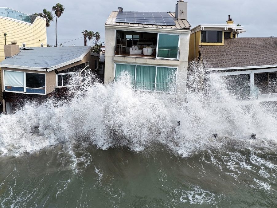 In an aerial view, Pacific Ocean waves wash into damaged homes amid high surf generated by Tropical Storm Rachel in Long Beach, California on Sunday. California was under its second-ever tropical storm watch, with coastal flood warnings in effect from Los Angeles to San Diego. An emerging El Niño and oceanic Kelvin wave moving up the coastline have compounded conditions in the region.