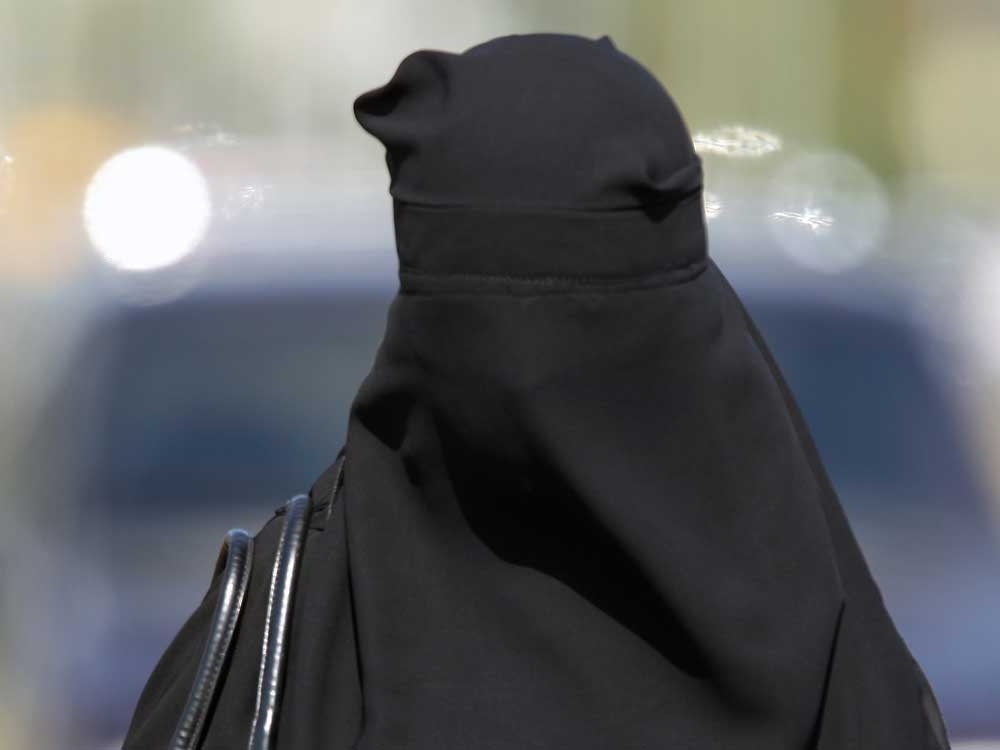 Anti-migrant protester Timothy Miller appears in court wearing a burka