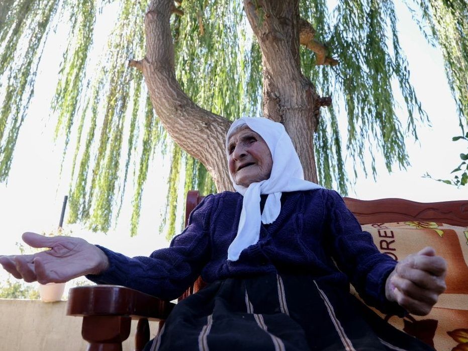 Qamile Marra, whose birth certificate shows she is 117, posed during an interview with AFP in the garden of her home in the Albanian village of Ferras.