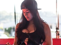 Lucero Acosta strapping on gloves.