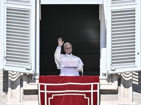 Pope Leo XIV waves to faithful during the Angelus prayer from the window of the Apostolic Palace overlooking St. Peter's Square, in the Vatican, on Oct. 11, 2026.