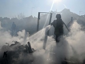 A firefighter extinguishes a fire in private houses following a Russian guided aerial bomb attack that killed one person, amid the Russian invasion of Ukraine, in Kharkiv on Oct. 11, 2026.