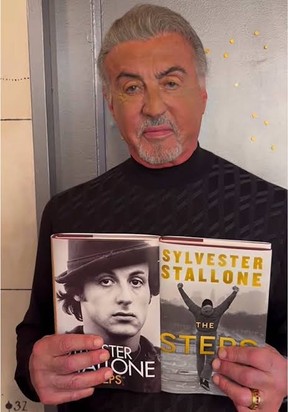 Sylvester Stallone poses with a copy of his memoir ‘The Steps.’