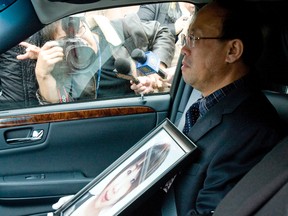 Qian "Necole" Liu’s father holds a photo of her as he leave her funeral service on Wednesday. (DAVE THOMAS/Toronto Sun)