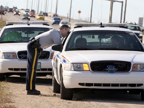 RCMP officers confer on the north Perimeter Highway near Henderson Highway in Winnipeg following a fatal three-vehicle traffic collision on Thursday, May 5, 2011. (BRIAN DONOGH, Winnipeg Sun)