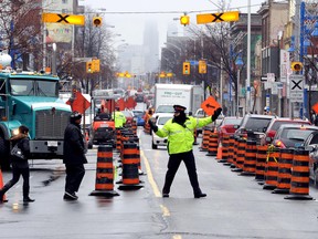 Toronto Police officers on paid duty get $65 an hour to direct traffic around construction sites and movie shoots. (DAVE ABEL/Toronto Sun file photo)