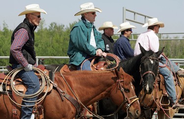 Cowboys watch the team roping event during the Rainmaker Rodeo in St. Albert, Saturday May 28, 2011. (DAVID BLOOM/EDMONTON SUN)