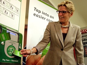 Then-transportation minister Kathleen Wynne shows how the Presto card works at Union Station in this September 2010 file photo. (Toronto Sun files)